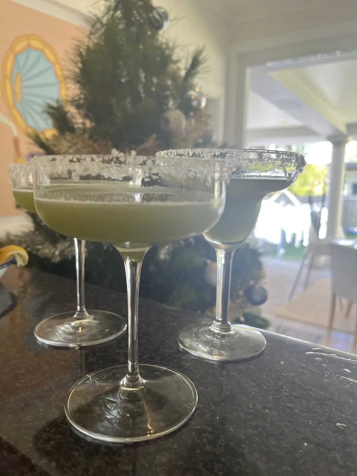Two salt-rimmed margarita coupes side by side